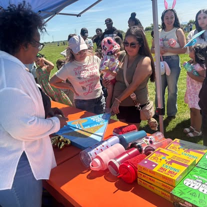 Councilwoman K. Patrice Williams greeting families at the prize table at the Easter Round-Up at Mile High Ranch