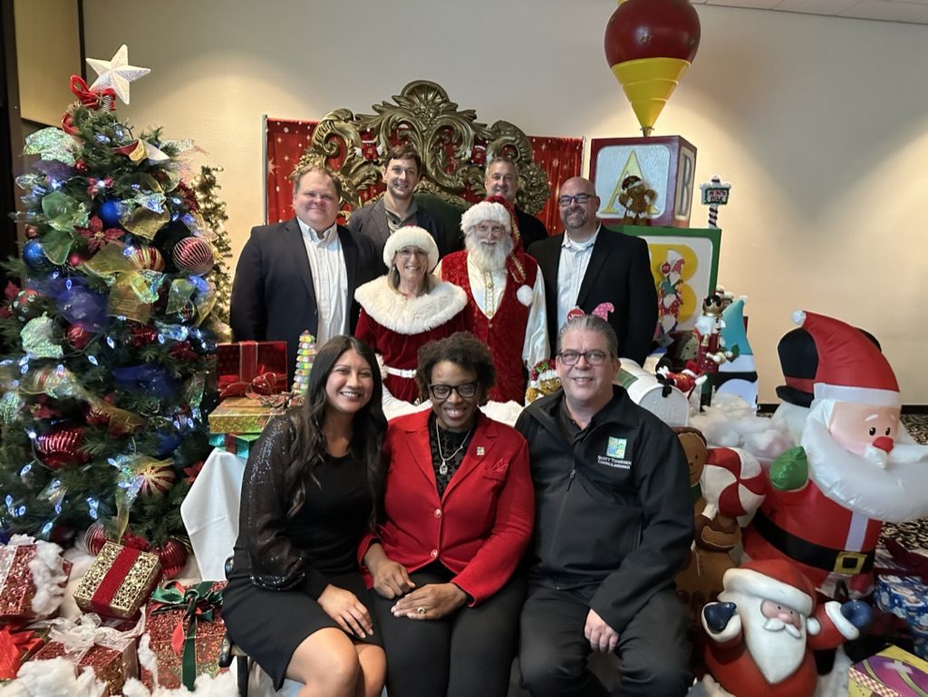 K. Patrice Williams with Santa, Mrs. Claus and guests at a holiday celebration at Jelly Belly in Fairfield