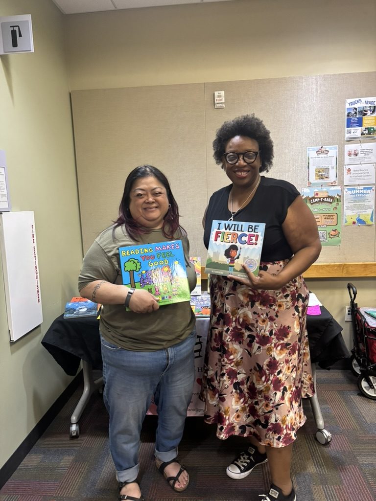 K. Patrice Williams holding a children's book at the Read Along at the Fairfield-Cordelia Library